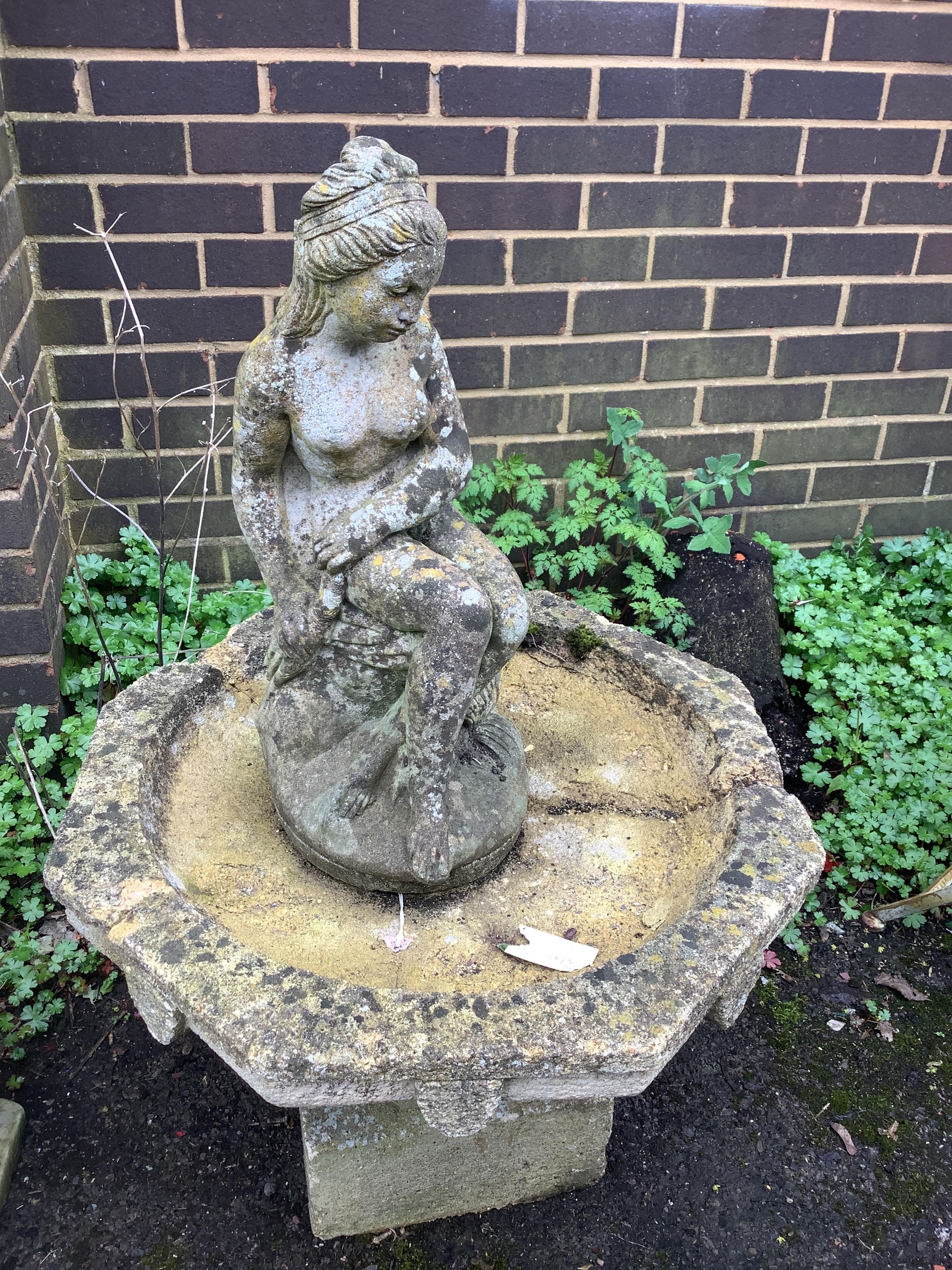 A circular reconstituted stone figural bird bath, height 102cm